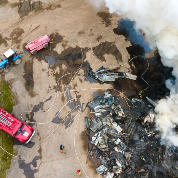 aerial-view-of-firemen-fighting-with-fire-near-old-2023-11-27-04-50-31-utc