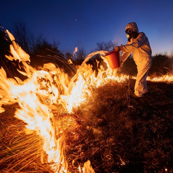 fireman-ecologist-extinguishing-fire-in-field-in-t-2023-11-27-05-02-45-utc